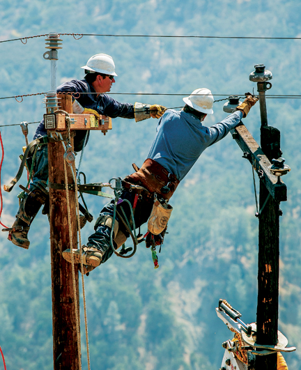 IBEW 1245 members from PG&E replace poles in steep terrain after being destroyed by the "Rocky Fire" in Clearlake, Calif., on August 6th, 2015.